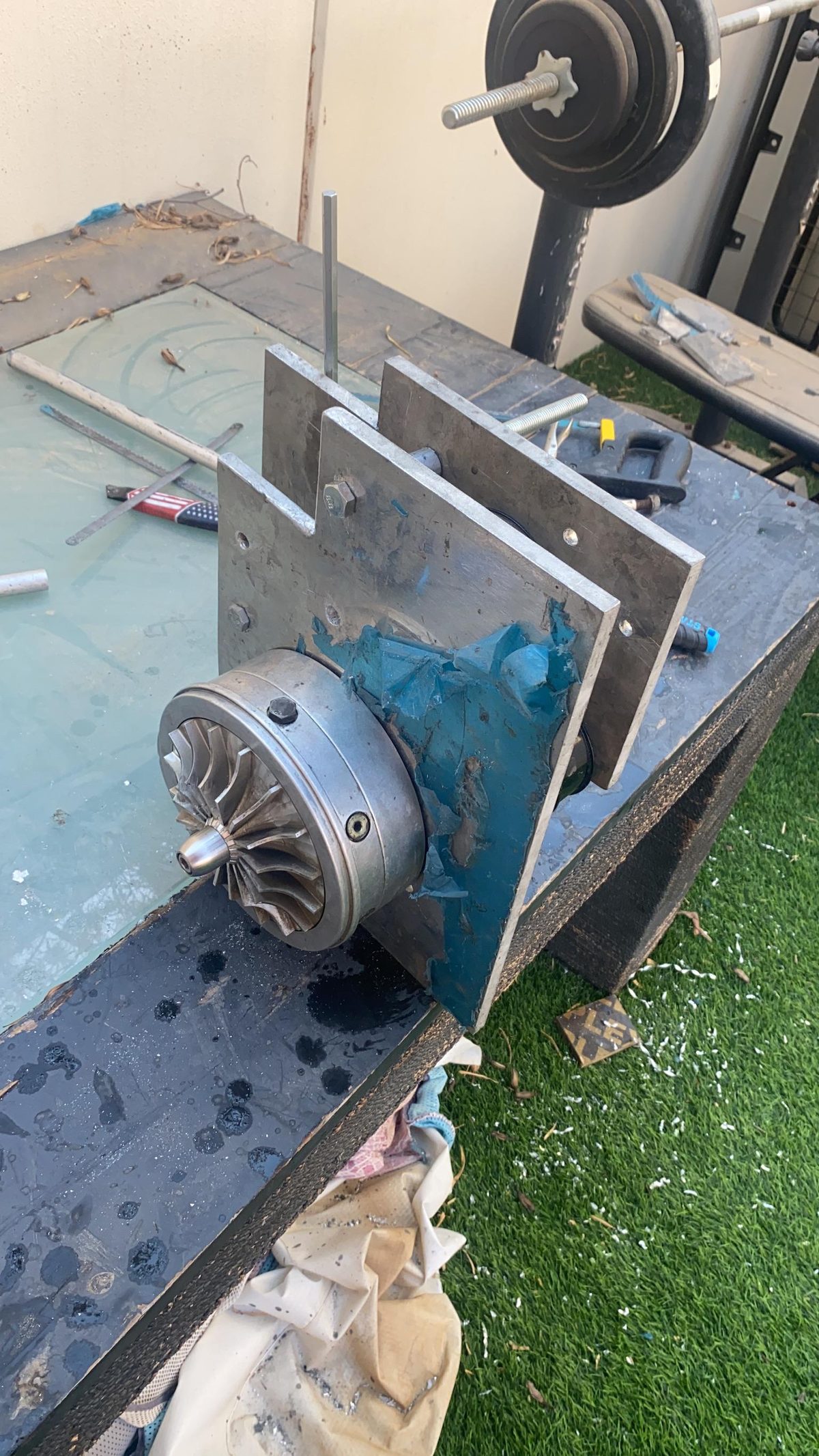 ProCharger impeller close up on the bench, bracket frame around it.