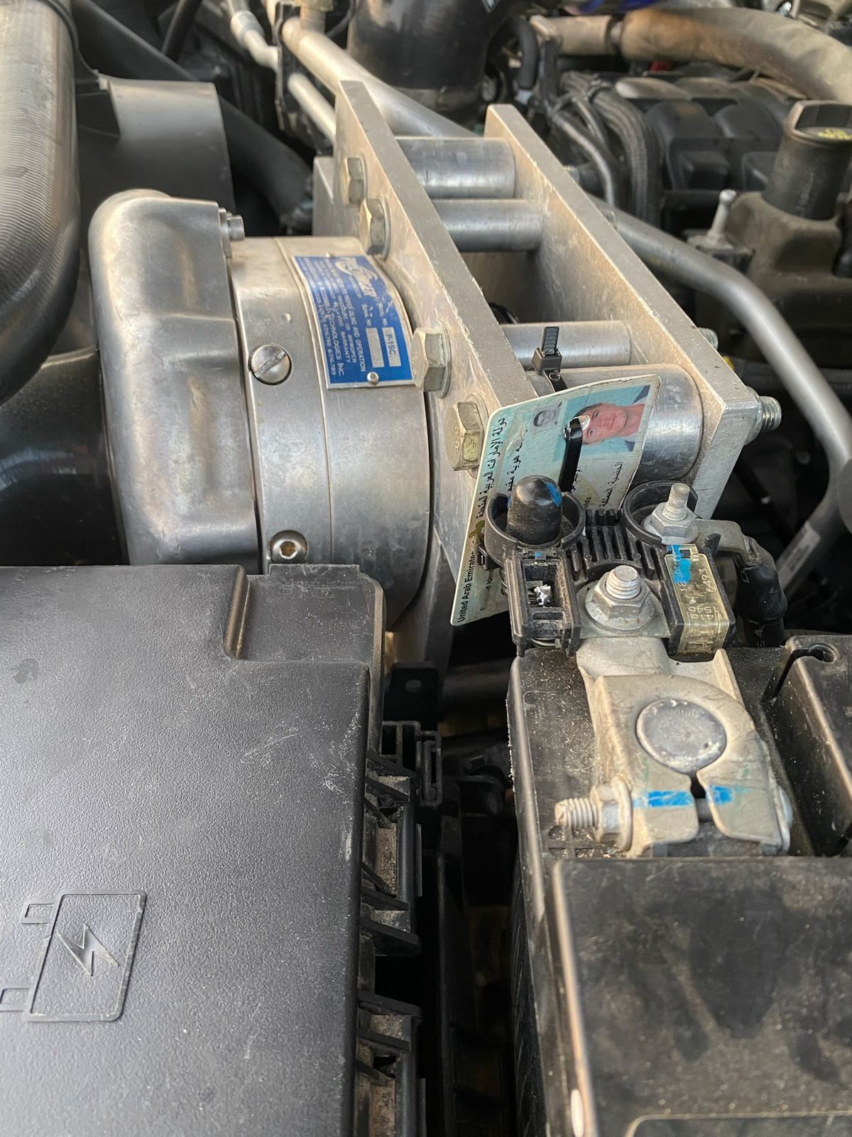 ProCharger test-fit near the battery box with cardboard packing for clearance.
