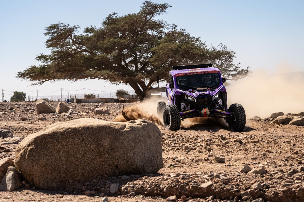 Vendetta Racing UTV at Jordan Baja 2026, sliding past a lone acacia tree in the desert.